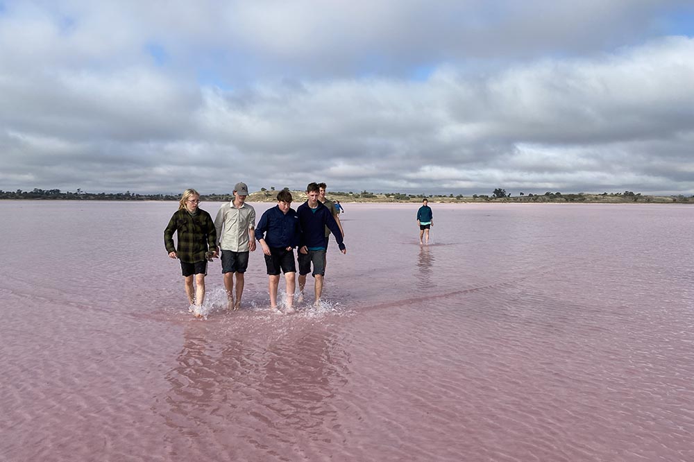 Students walking on a pink lake in the Murray Darling Sunset National Park